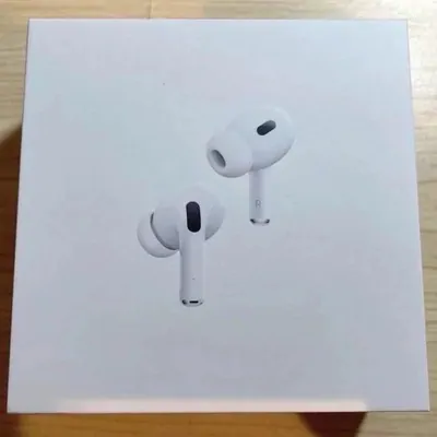 Wireless earbuds resting on their open white charging case